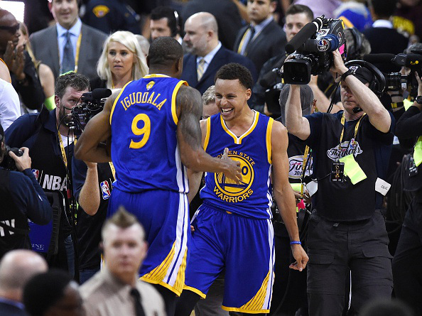 MISSION ACCOMPLISHED --- Golden State Warriors Stephen Curry and MVP Andre Iguodala celebrate after their team defeated the Cleveland Cavaliers in Game 6 to win the 2015 NBA Finals on June 16, 2015 at the Quicken Loans Arena in Cleveland, Ohio. The Warriors took the best-of-seven series four games to two over the Cavaliers to claim their first title since 1975. (Photo by Timothy Clary/Getty Images)